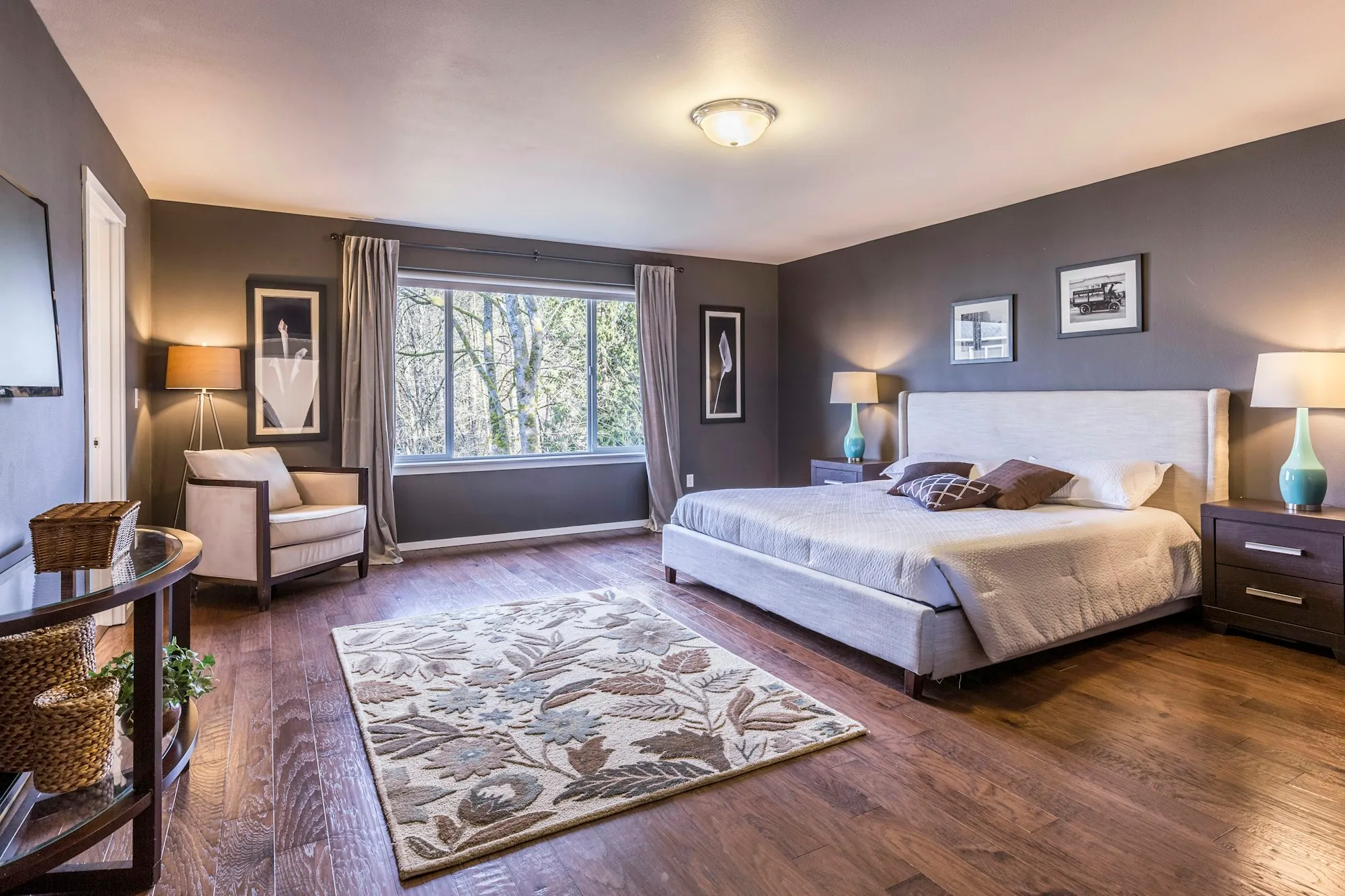 Spacious bedroom with a large bed and hardwood floors